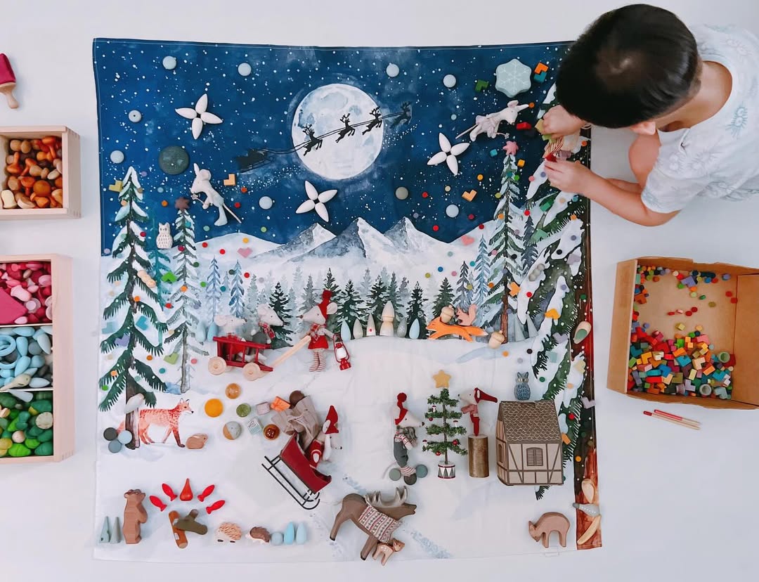 A child playing with wooden toys on a Wonderie cloth